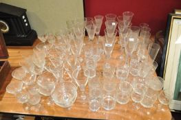 A suite of wine glasses and a quantity of cut glass