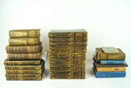 A group of assorted leather quarterbound volumes of Dickens and other books