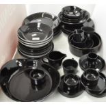 A collection of assorted black plates, cups and more,