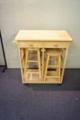 A pine kitchen table and stools unit