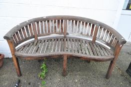 A carved teak garden bench