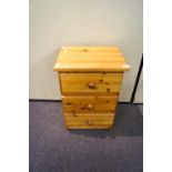 A yellow pine chest of three drawers