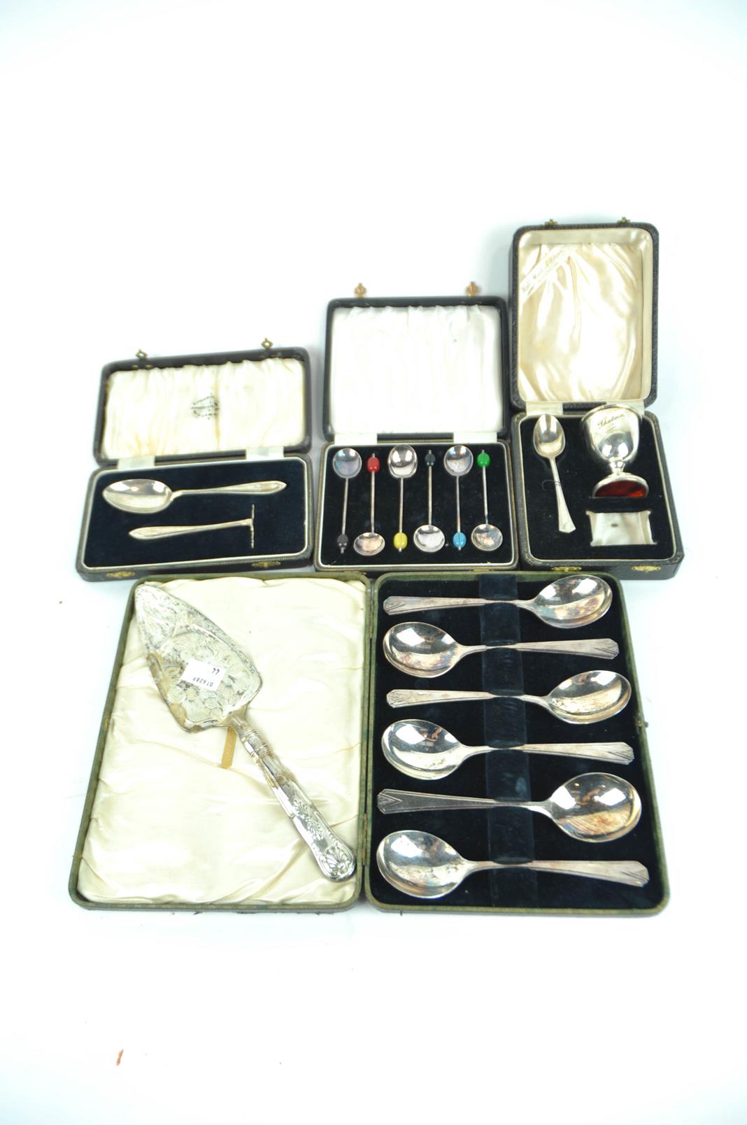 A collection of boxed silver plate coffee bean spoons,