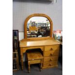 A pine dressing table and a stool