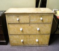 A two over two pine chest of drawers having a scumble painted finish with ceramic knob handles
