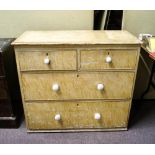 A two over two pine chest of drawers having a scumble painted finish with ceramic knob handles