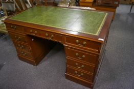 A mahogany pedestal desk with leather inset top
