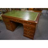 A mahogany pedestal desk with leather inset top