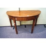 A mahogany 'D' end table with fitted frieze and raised on square legs,