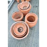 A quantity of moulded terracotta garden pots