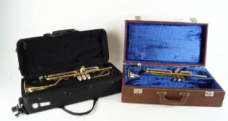 Two cased trumpets