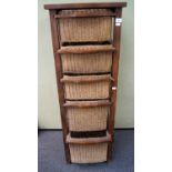 A 2oth century teak wood and wicker drawer unit with five wicker basket drawers of graduating sizes