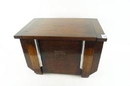 A lidded wooden log box,