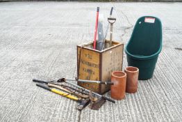 A selection of tools and a terracotta pipe