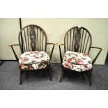 A pair of Ercol armchairs with Prince of Wales feather splats