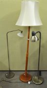 A collection of three standard lamps, to include a brass lamp, teak lamp and another,