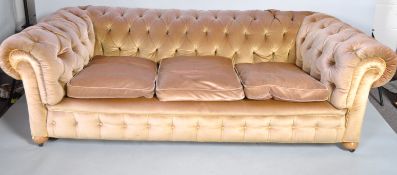 A Chesterfield three seater sofa, upholstered in beige velvet,