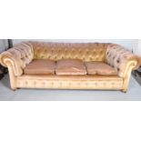 A Chesterfield three seater sofa, upholstered in beige velvet,
