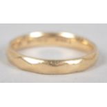 A yellow metal 3.0mm wedding ring having a diamond faceted design.