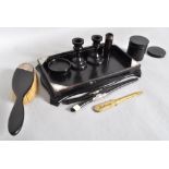 An early 20th century ebony part dressing table set some with silver mounts,