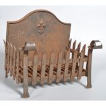 A 20th century wrought iron fire grate and back,