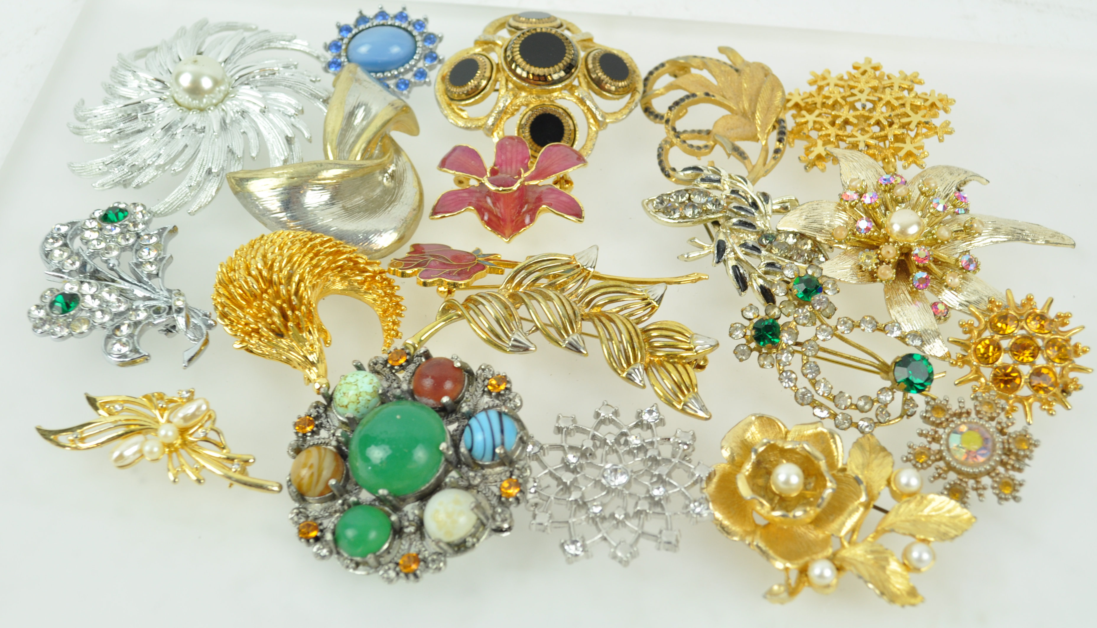 A collection of twenty costume brooches of variable design.
