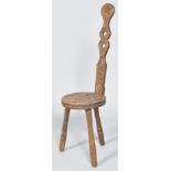 A Carved Ben Setter Totnes Celtic spinning stool, with tall pierced back with foliate rondel,