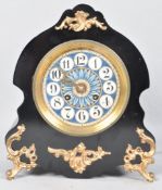 A late 19th century French mantel clock, the ebonised case of scrolled form with gilt metal mounts,