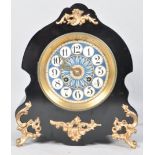 A late 19th century French mantel clock, the ebonised case of scrolled form with gilt metal mounts,