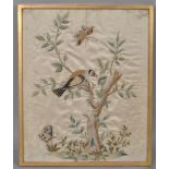 An early 19th century silk embroidery of a goldfinch confronting a caterpillar in a tree,