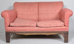 A mahogany two seat sofa, with Chippendale style blind fretwork legs and frame,