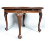 A mahogany extending dining table in the George III style, of circular form with one leaf,