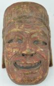 A carved wood and painted face mask,