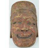 A carved wood and painted face mask,