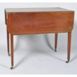 An Edwardian mahogany Pembroke table with box wood and ebony feather banding to the top,
