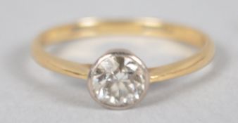 A yellow and white metal ring set with an early brilliant cut diamond estimated to weigh 0.50cts.