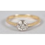 A yellow and white metal ring set with an early brilliant cut diamond estimated to weigh 0.50cts.
