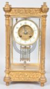 A late 19th century gilt four glass mantel clock,