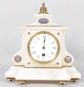 A late 19th century French alabaster mantel clock of cantered rectangular form,