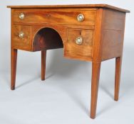 A Regency mahogany kneehole desk, circa 1820, with ebony string inlay and plate glass top,