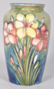 A Moorcroft pottery Lily pattern tube lined vase, impressed marks and signature to the base,