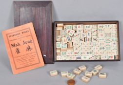 A vintage mahjong set having bone and bamboo tiles with dove tail joints,