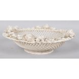 A Belleek lattice work porcelain basket, decorated to the rim with applied floral sprays,