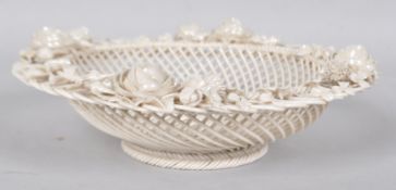 A Belleek lattice work porcelain basket, decorated to the rim with applied floral sprays,