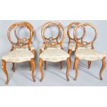 A set of six Victorian walnut balloon back chairs,
