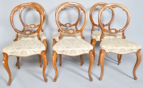 A set of six Victorian walnut balloon back chairs,