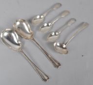 A pair of silver Art Deco style salad servers with lobed bowls and decorated handles