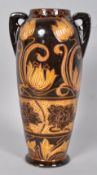 An early 20th century pottery two handled Art Nouveau style slipware 'Scrafitto' vase,