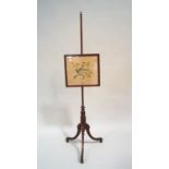 An early 19th century mahogany pole screen,