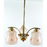 A 1930's three branch ceiling light, each pink glass light shade printed with a flower sprig,